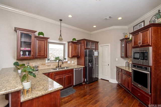 kitchen featuring pendant lighting, dark hardwood / wood-style flooring, light stone counters, sink, and appliances with stainless steel finishes