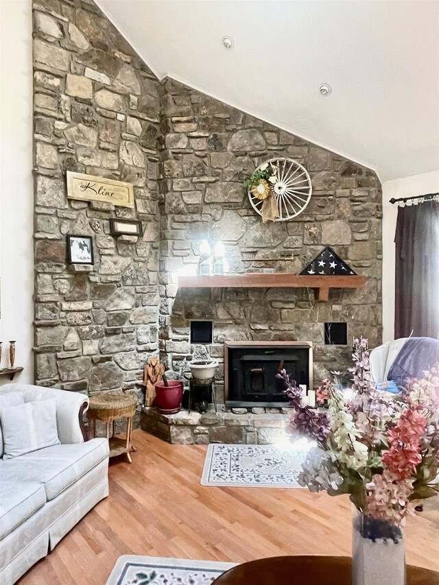 910 Nelsonville Rd, Smithville, AR 72466 - living room with high vaulted ceiling, a skylight, ceiling fan, wood finished floors, and a stone fireplace