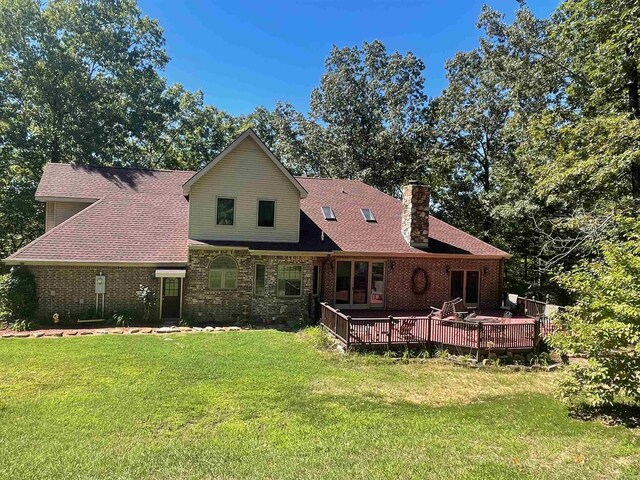 910 Nelsonville Rd, Smithville, AR 72466 - back of property featuring roof with shingles, a lawn, a deck, brick siding, and a chimney