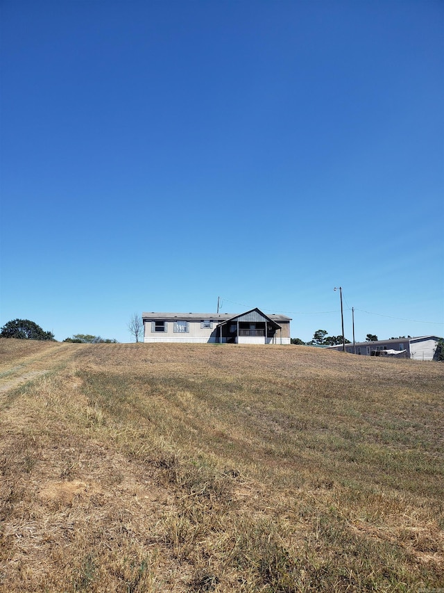 view of yard with a rural view