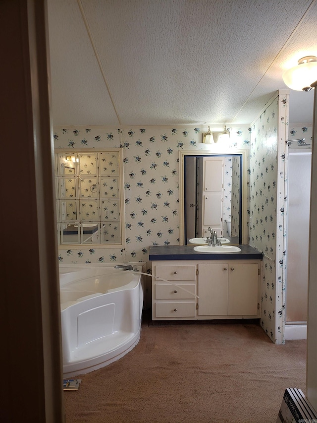 bathroom with vanity, a textured ceiling, and plus walk in shower