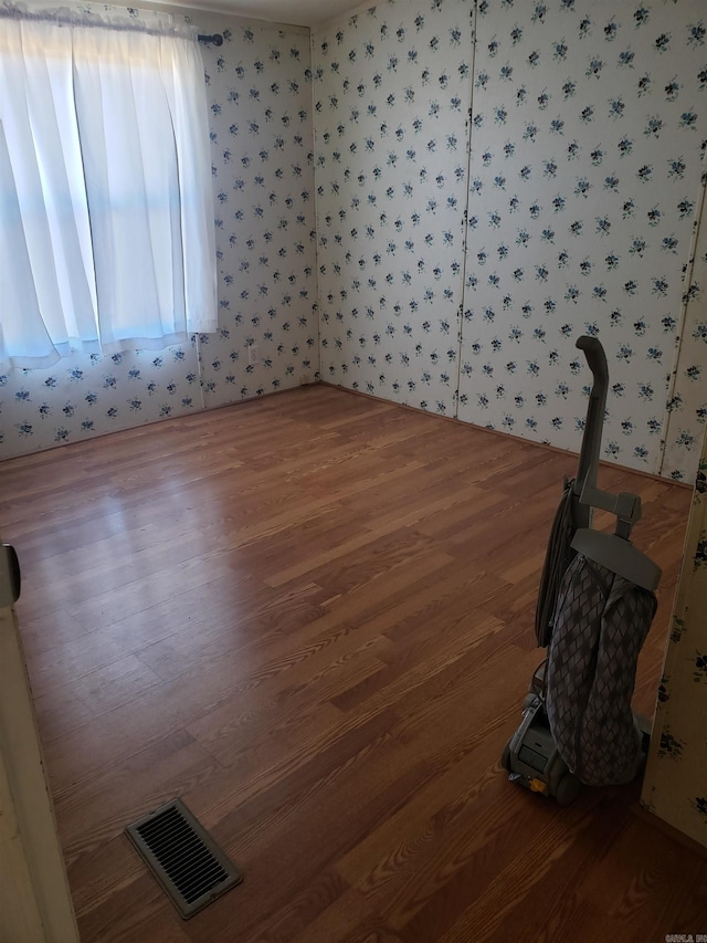 unfurnished room with dark hardwood / wood-style floors