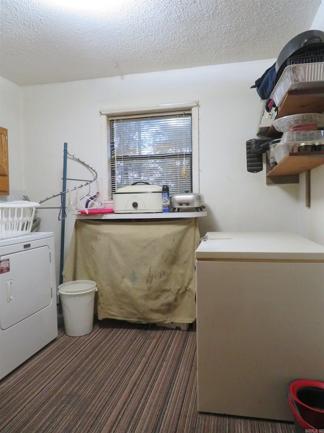 laundry room with washer / dryer and a textured ceiling