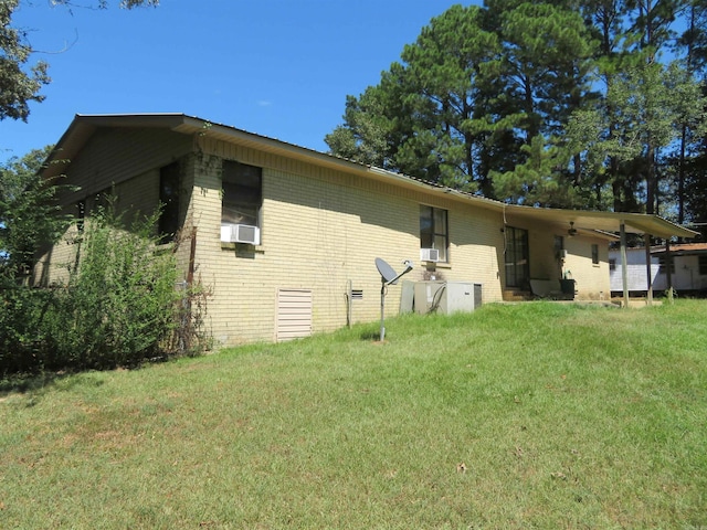 rear view of house with a yard and cooling unit