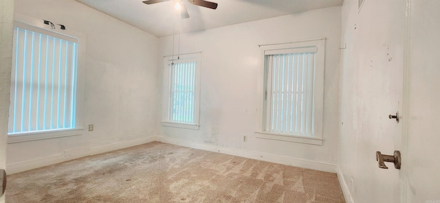 unfurnished room with light colored carpet and ceiling fan