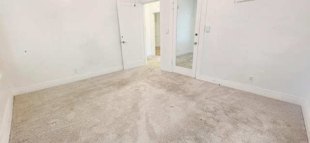 unfurnished bedroom featuring light carpet