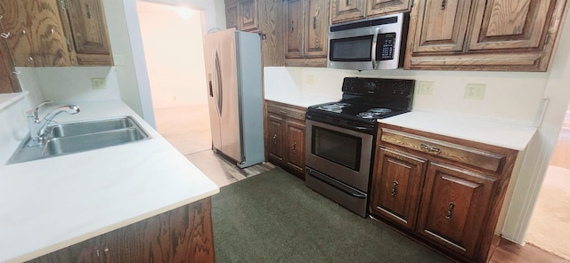 kitchen with sink, appliances with stainless steel finishes, and light hardwood / wood-style floors