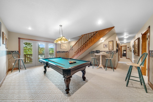 rec room with billiards, light colored carpet, and a textured ceiling