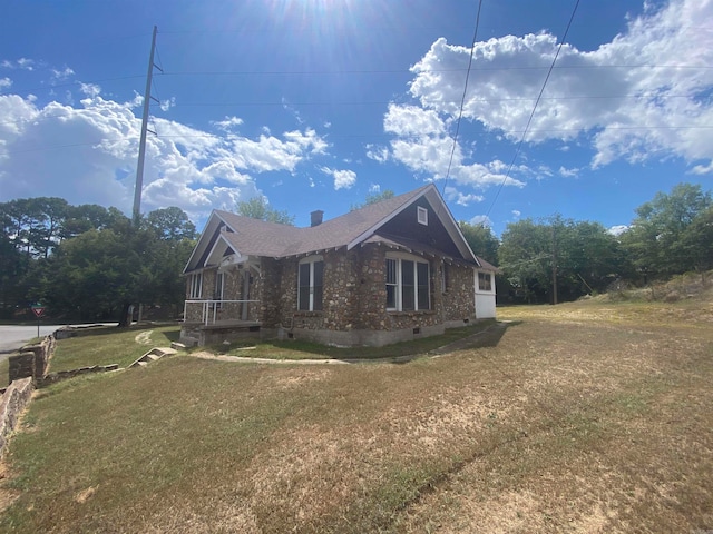 view of side of home featuring a yard