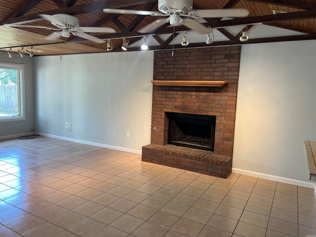 unfurnished living room with wooden ceiling, a fireplace, light tile patterned floors, and ceiling fan