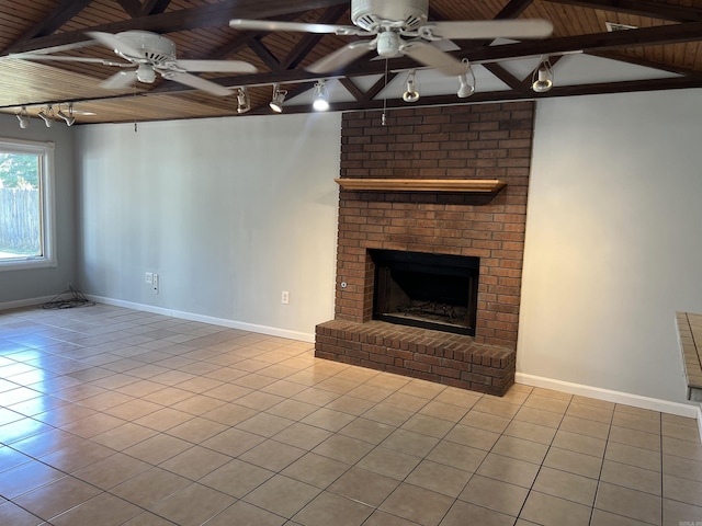 unfurnished living room with tile patterned flooring, a fireplace, beam ceiling, ceiling fan, and wood ceiling
