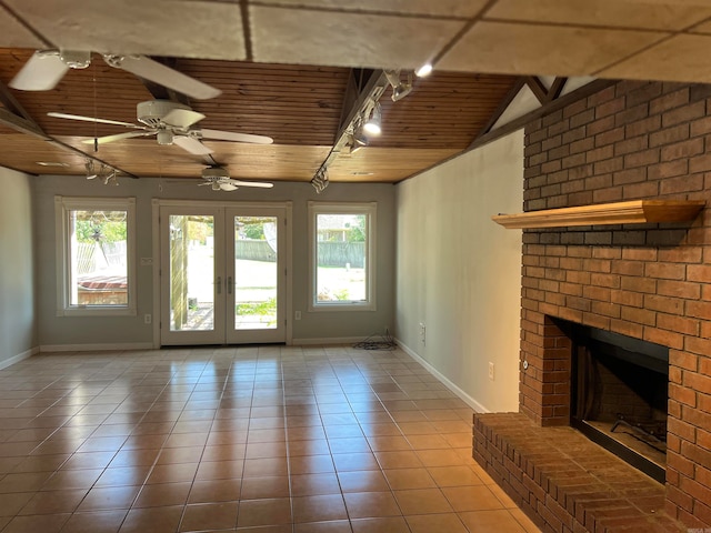 unfurnished living room featuring wood ceiling, a healthy amount of sunlight, ceiling fan, and a fireplace