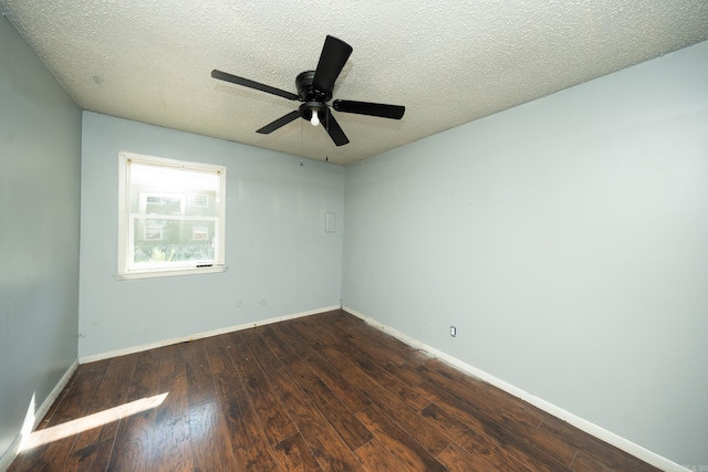 spare room featuring a textured ceiling, dark wood-type flooring, and ceiling fan