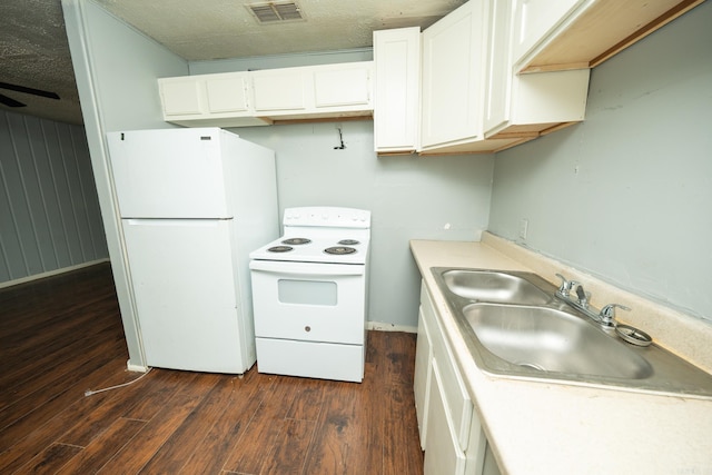 kitchen featuring white appliances, a textured ceiling, sink, dark wood-type flooring, and white cabinets