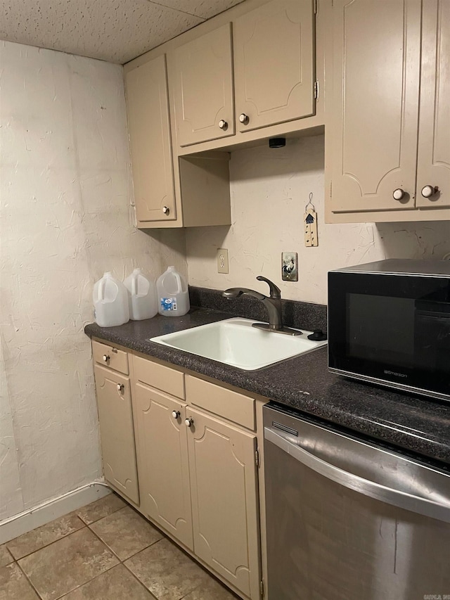 kitchen featuring dishwasher, light tile patterned floors, and sink