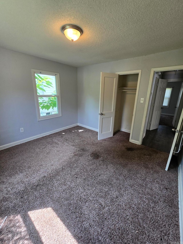 unfurnished bedroom featuring carpet flooring and a textured ceiling