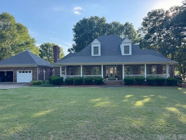 view of front facade with a garage, covered porch, and a front yard