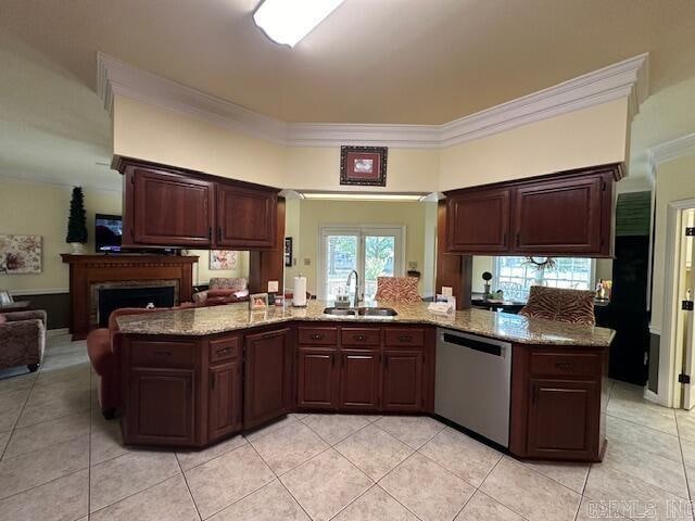 kitchen with light tile patterned floors, dishwasher, crown molding, light stone counters, and sink