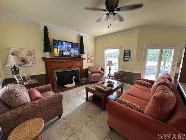 living room with ornamental molding, plenty of natural light, light tile patterned flooring, and ceiling fan