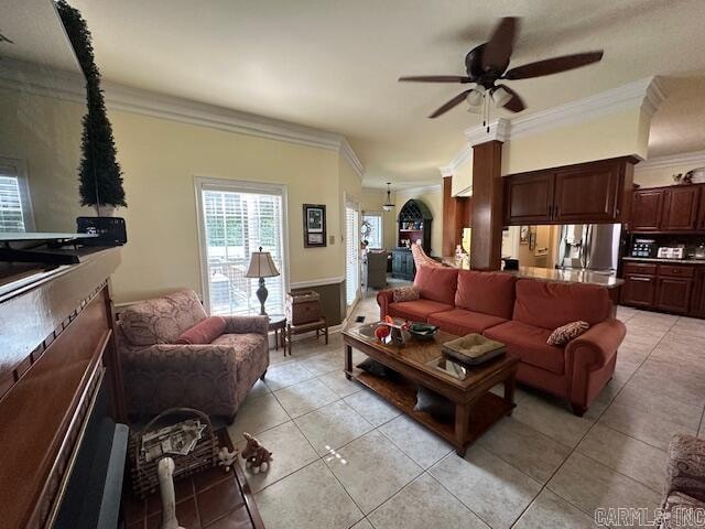 tiled living room featuring crown molding and ceiling fan