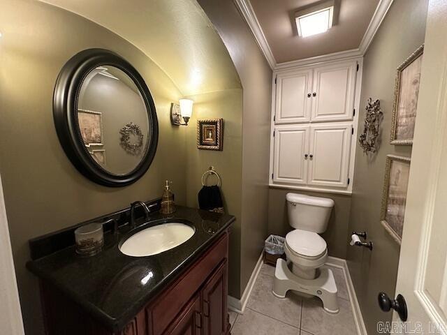 bathroom featuring tile patterned floors, vanity, toilet, and ornamental molding