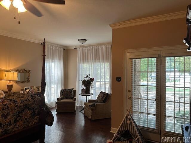 bedroom with ornamental molding, ceiling fan, and dark hardwood / wood-style floors