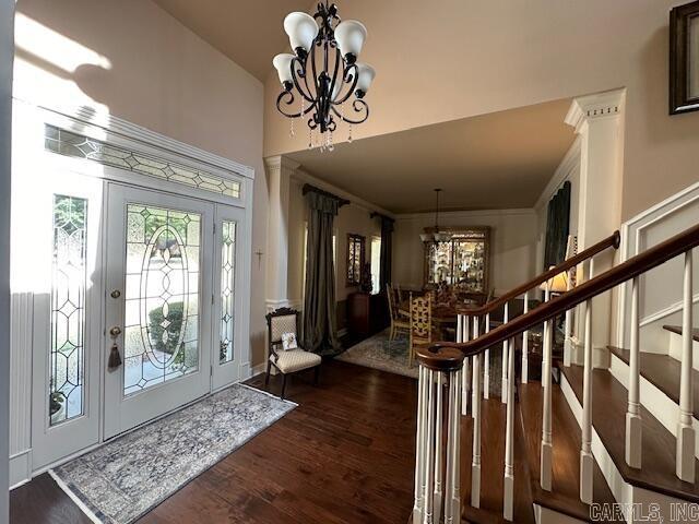 foyer entrance featuring dark hardwood / wood-style flooring and an inviting chandelier