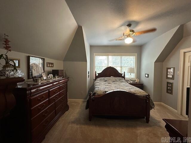 bedroom with ceiling fan, carpet floors, and vaulted ceiling