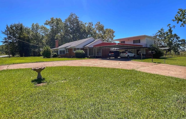 view of front facade with concrete driveway and a front yard
