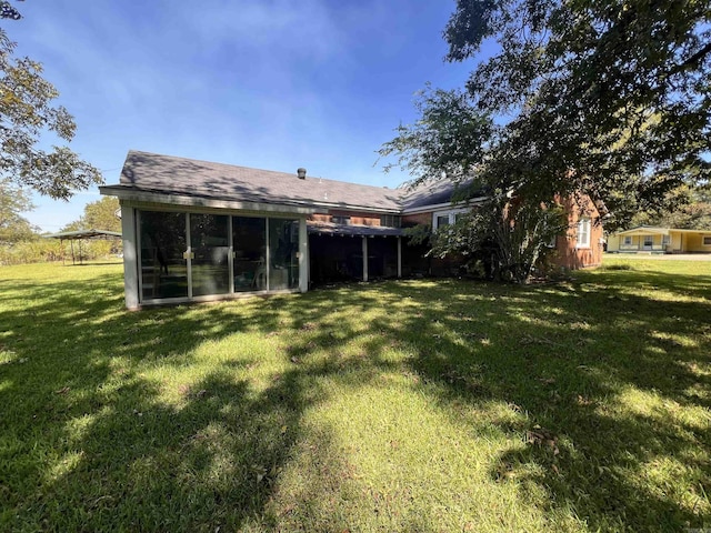 exterior space with a yard and a sunroom