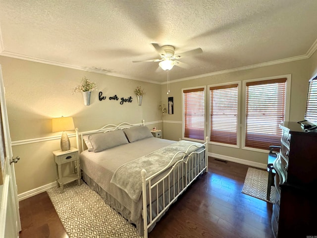 bedroom with a textured ceiling, ceiling fan, ornamental molding, and dark hardwood / wood-style flooring