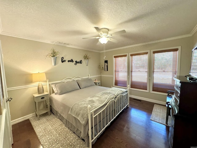 bedroom featuring visible vents, wood finished floors, crown molding, baseboards, and ceiling fan