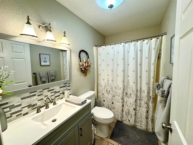 bathroom featuring a textured ceiling, vanity, tasteful backsplash, tile patterned flooring, and toilet