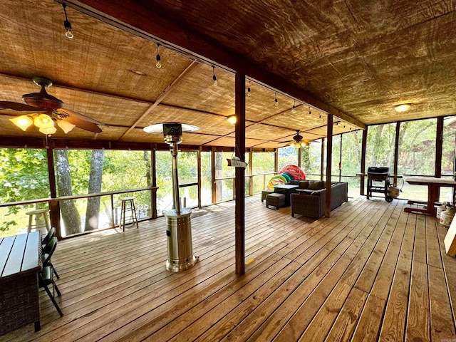 unfurnished sunroom featuring ceiling fan