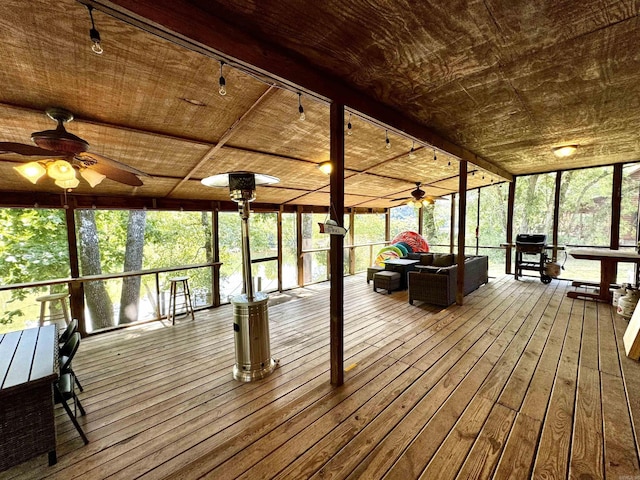 wooden terrace featuring a ceiling fan