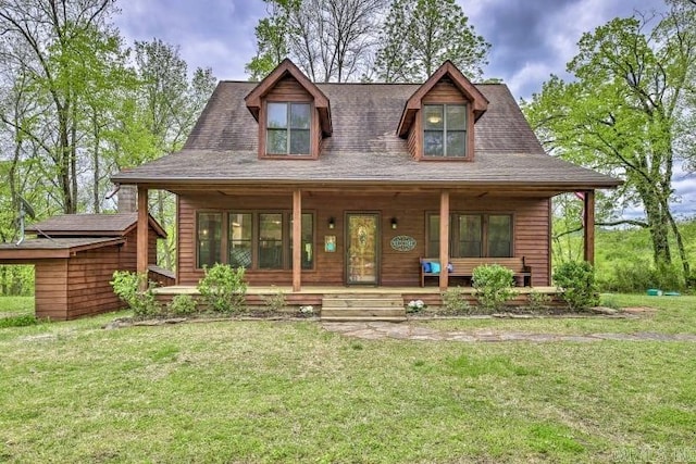 chalet / cabin featuring a porch and a front lawn