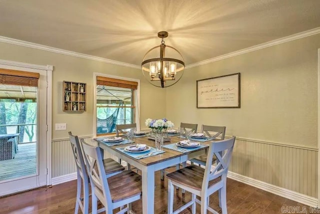 dining space with dark wood-type flooring and crown molding