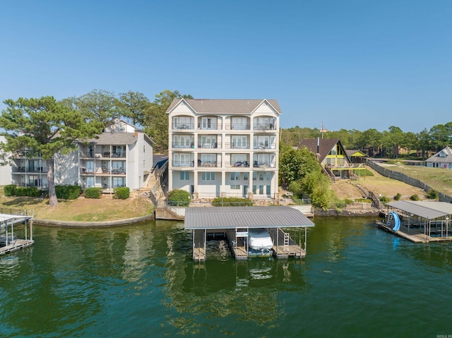 dock area with a balcony and a water view