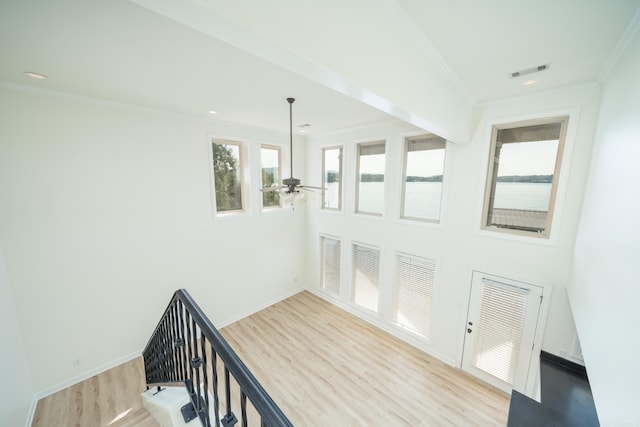 interior space with crown molding, wood-type flooring, and ceiling fan