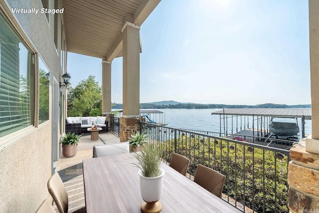 balcony with a water view and an outdoor living space