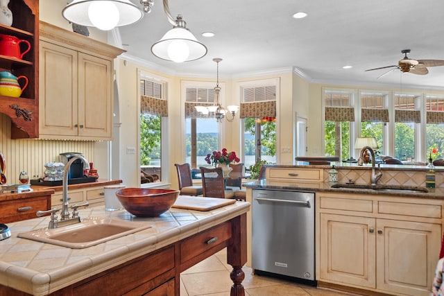 kitchen with light tile patterned floors, dishwasher, tile counters, and sink