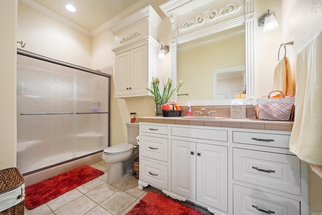 bathroom featuring toilet, tile patterned floors, a shower with door, ornamental molding, and vanity