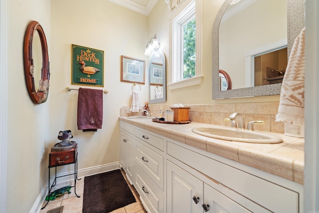 bathroom with tile patterned flooring, decorative backsplash, crown molding, and vanity