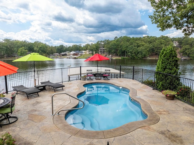 view of swimming pool featuring a patio and a water view