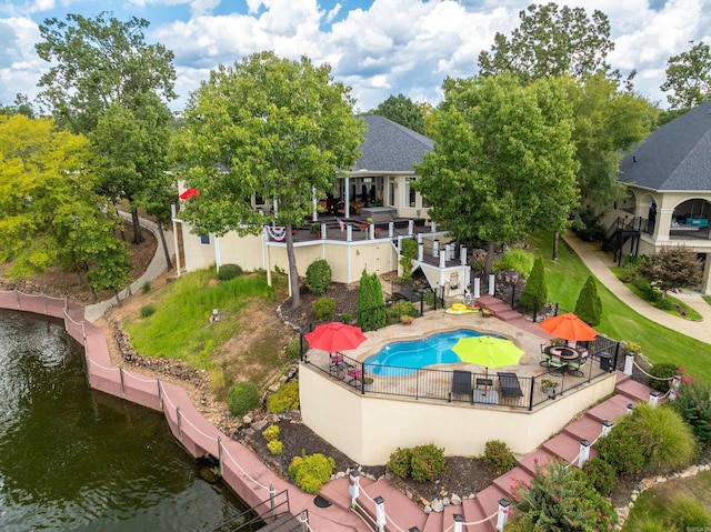 view of swimming pool featuring a patio area and a water view