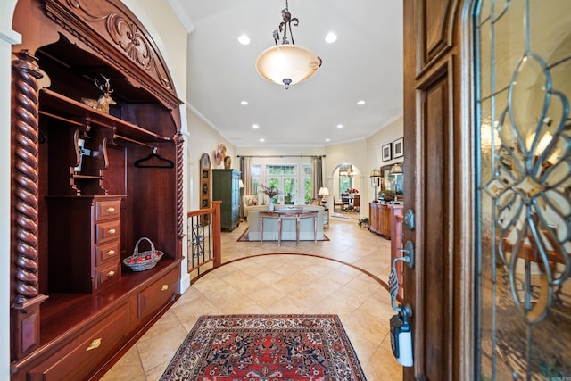 tiled entrance foyer featuring ornamental molding