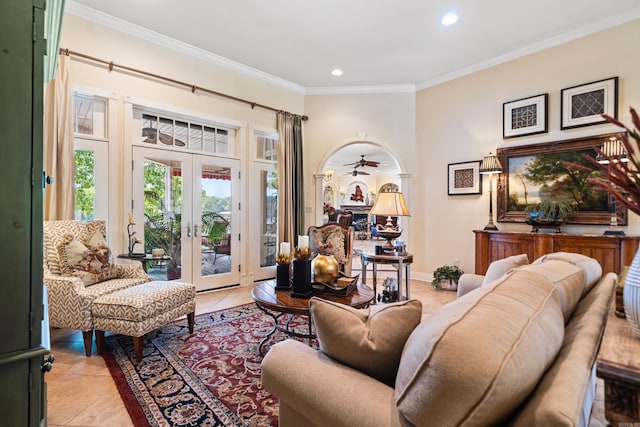 tiled living room featuring crown molding, french doors, and ceiling fan