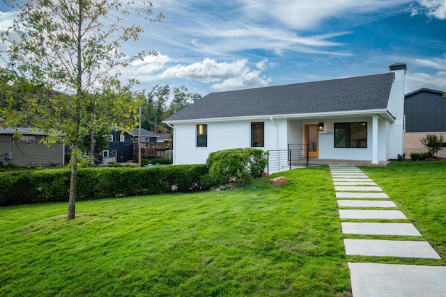 view of front of home with a porch and a front lawn