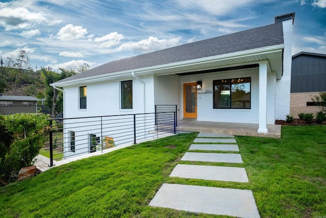 exterior space with a lawn and covered porch