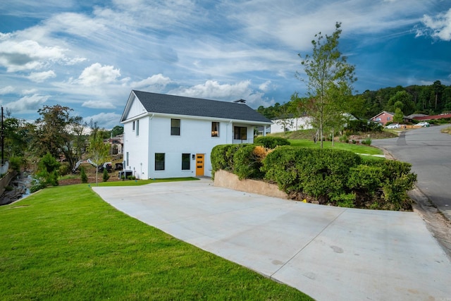 view of home's exterior with a yard and central AC